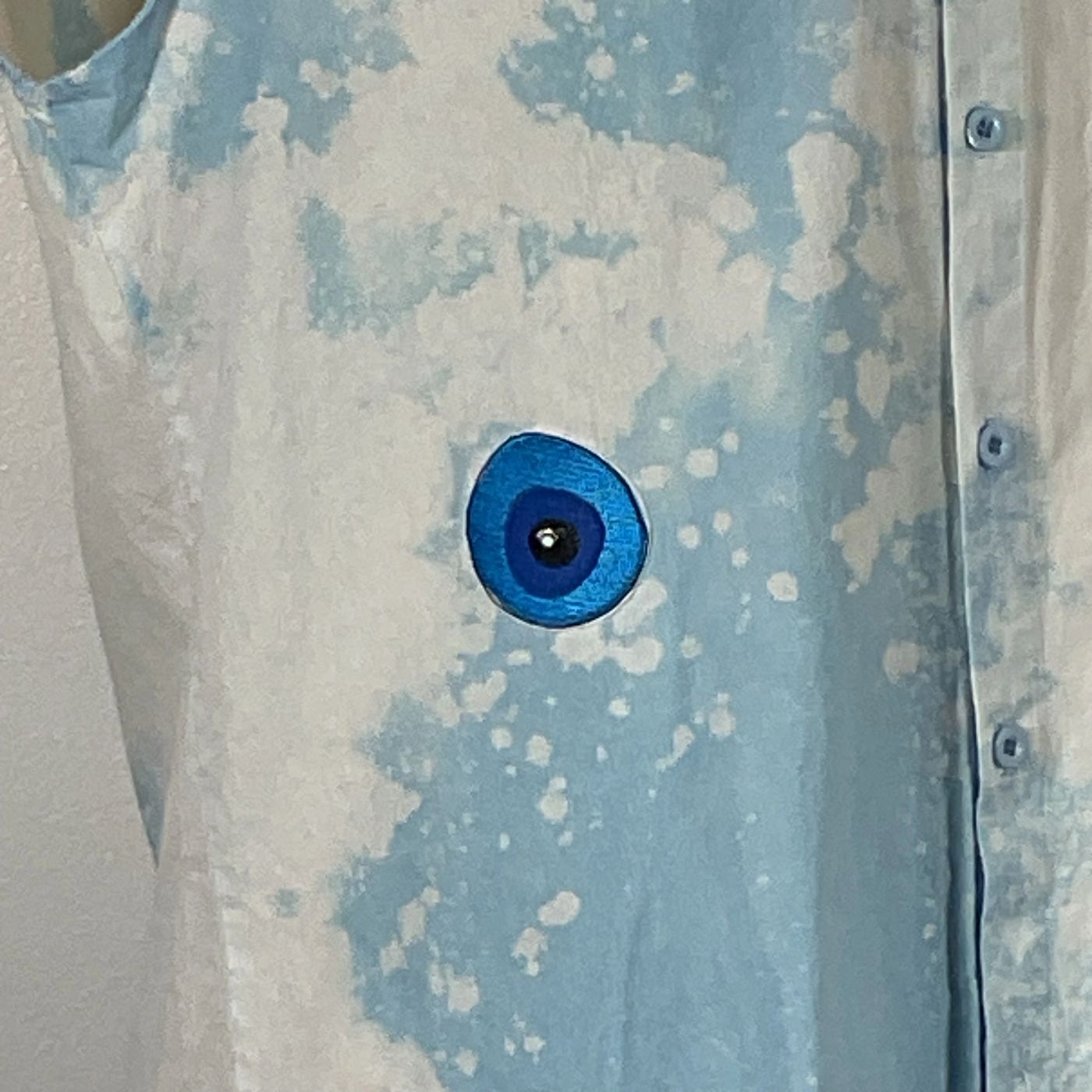 PADRINO SHARK Men's Custom Sleeveless Shirt featuring a striking blue eye design on the front, embodying unique, bold wearable art from DEVIOUS SAINT.
