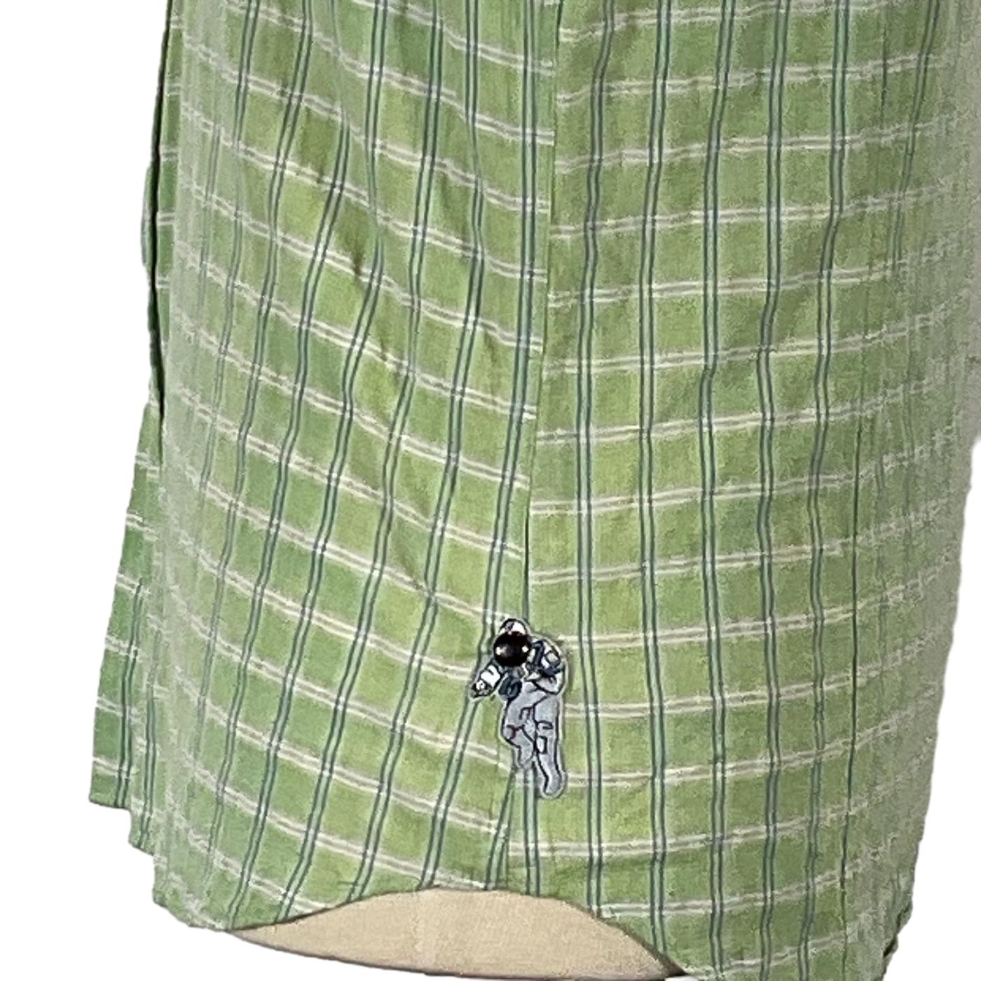 TYPEWRITER Men's Custom Sleeveless Shirt featuring a green and white plaid pattern, cartoon character embellishment, and unique design elements, embodying DEVIOUS SAINT's bold, artistic style.
