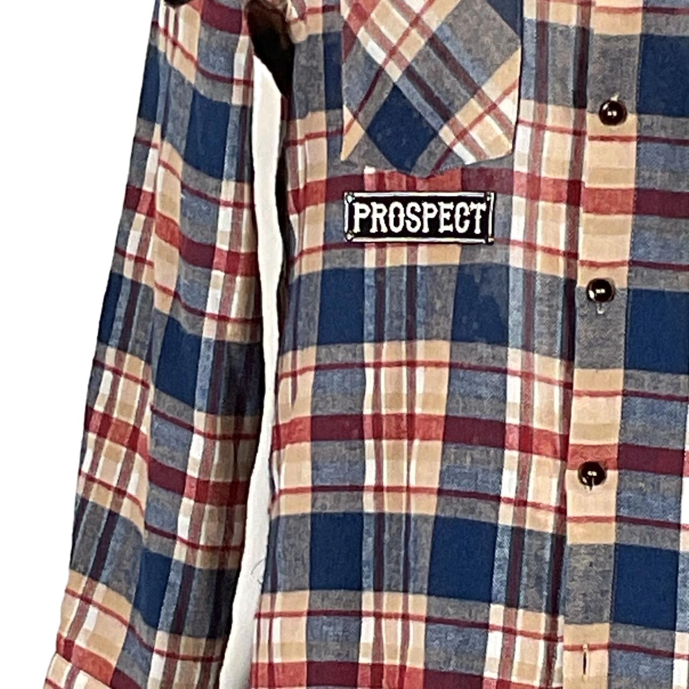 Close-up of the PERMANENTLY TIRED Men's Custom Long-Sleeve Flannel Shirt featuring a unique tartan pattern with visible buttons, reflecting DEVIOUS SAINT's distinctive style.
