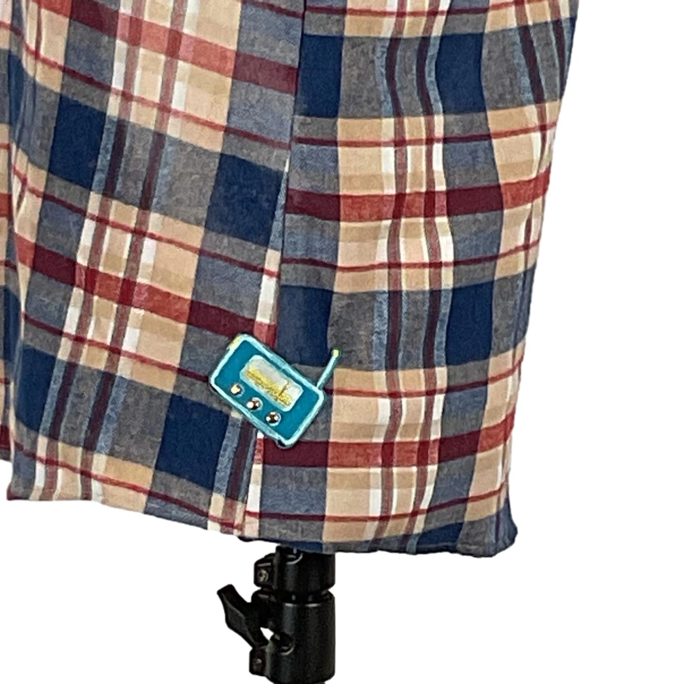 Close-up of the PERMANENTLY TIRED Men's Custom long-Sleeve Flannel Shirt, showcasing its distinctive plaid pattern and button detail, embodying DEVIOUS SAINT's bold, unique style.