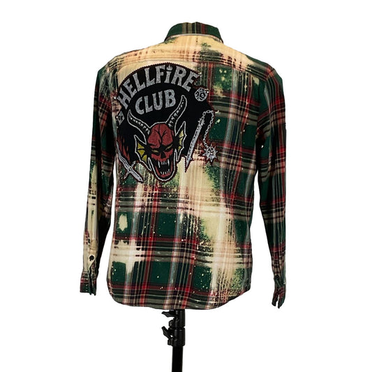 HELLFIRE Men's Custom Long-Sleeve Flannel Shirt displayed on a mannequin, featuring a plaid pattern with a distinctive skull patch.