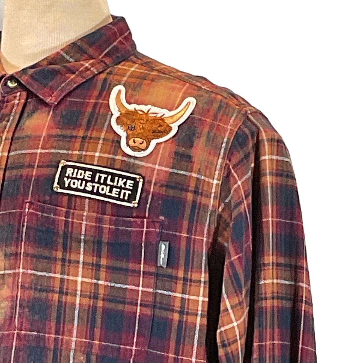 CASSETTE Men's Custom Long-Sleeve Flannel Shirt featuring a plaid pattern and a bull patch, embodying DEVIOUS SAINT's unique and bold wearable art style.