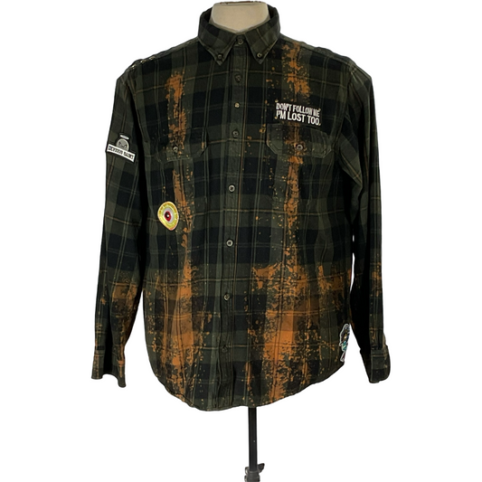 Green and black flannel shirt with bleached treatment, hand-patched details, and metal studs, embodying a unique vintage aesthetic, titled GET FUNKED UP.