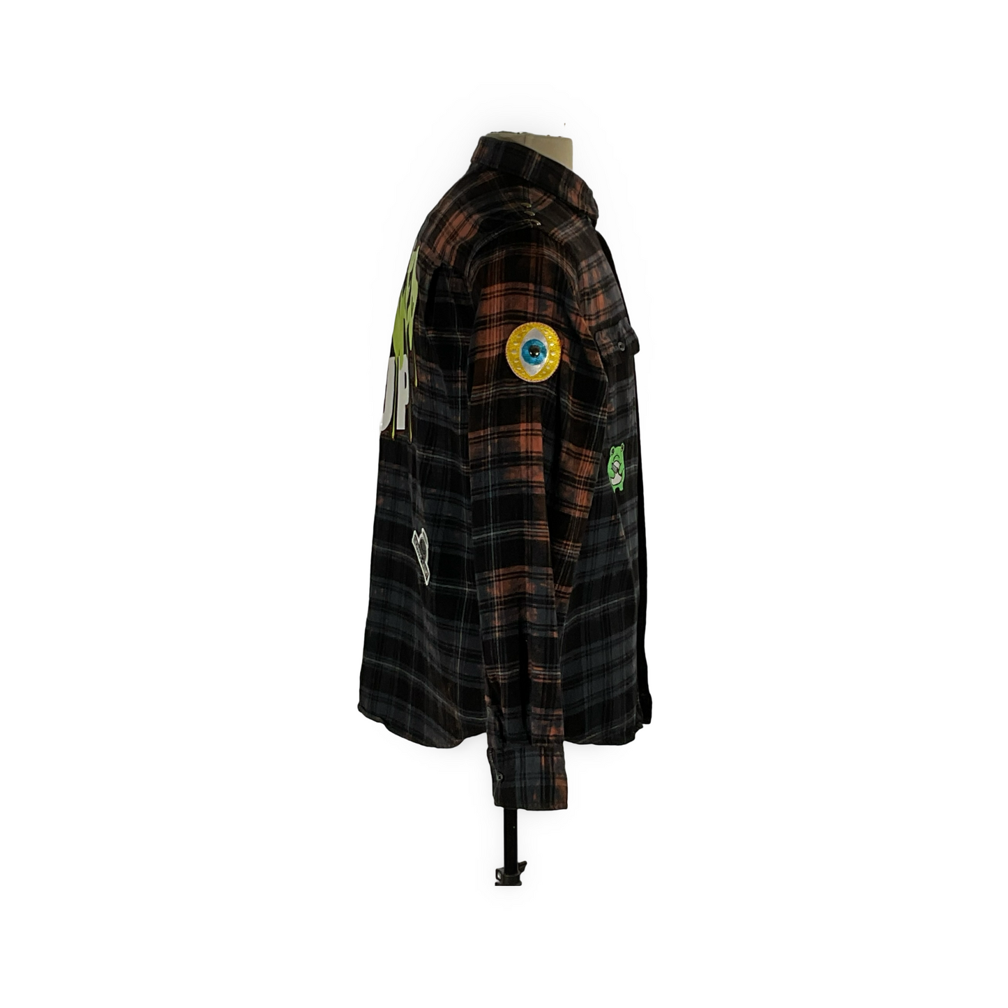 GET FUNKED UP: A unique black plaid flannel shirt with hand-patched details and metal studs, embodying sustainable fashion and a vintage aesthetic.