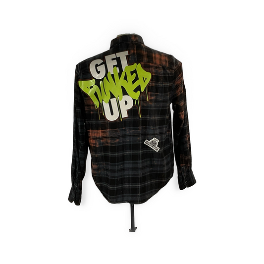 Back view of an I'M NOT GETTING OLDER, I'M BECOMING A CLASSIC flannel featuring graffiti, unique patches, and metal studs, embodying sustainable, bold fashion.