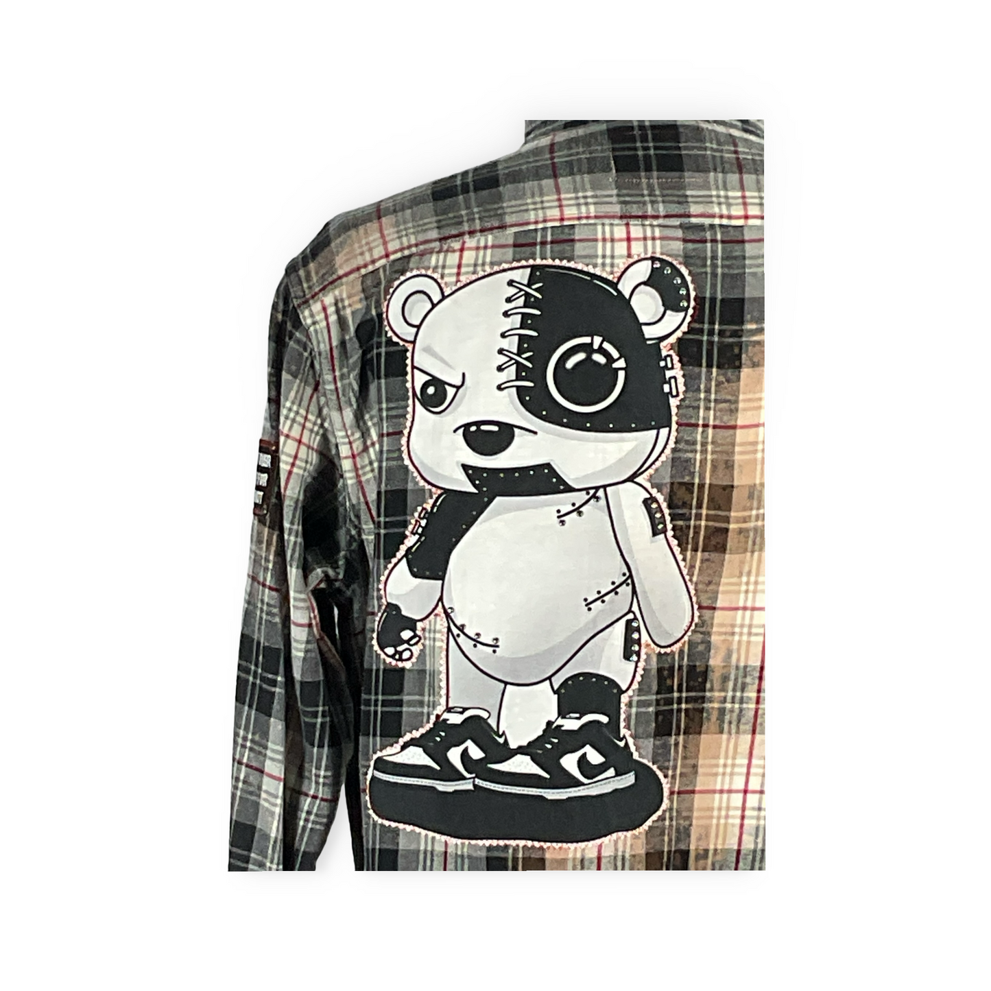 Cyber Bear flannel featuring a cartoon bear on a plaid shirt, showcasing hand-patched details and metal studding for a unique, sustainable vintage look.