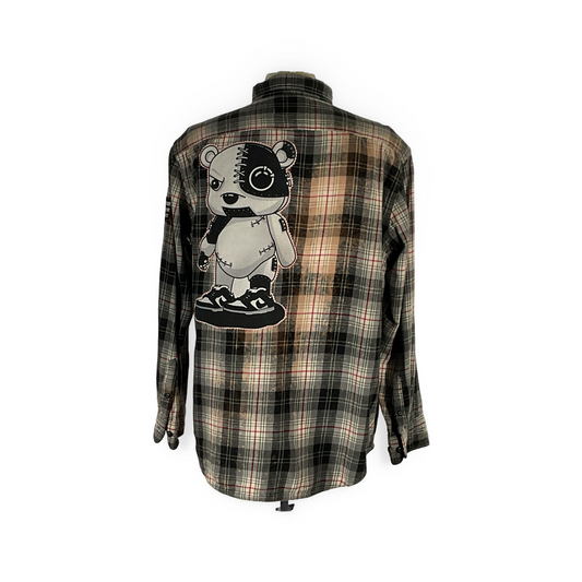 Cyber Bear plaid shirt featuring cartoon bear, hand-patched details, and metal studs, showcasing DEVIOUS SAINT's unique, sustainable fashion through a vintage aesthetic.