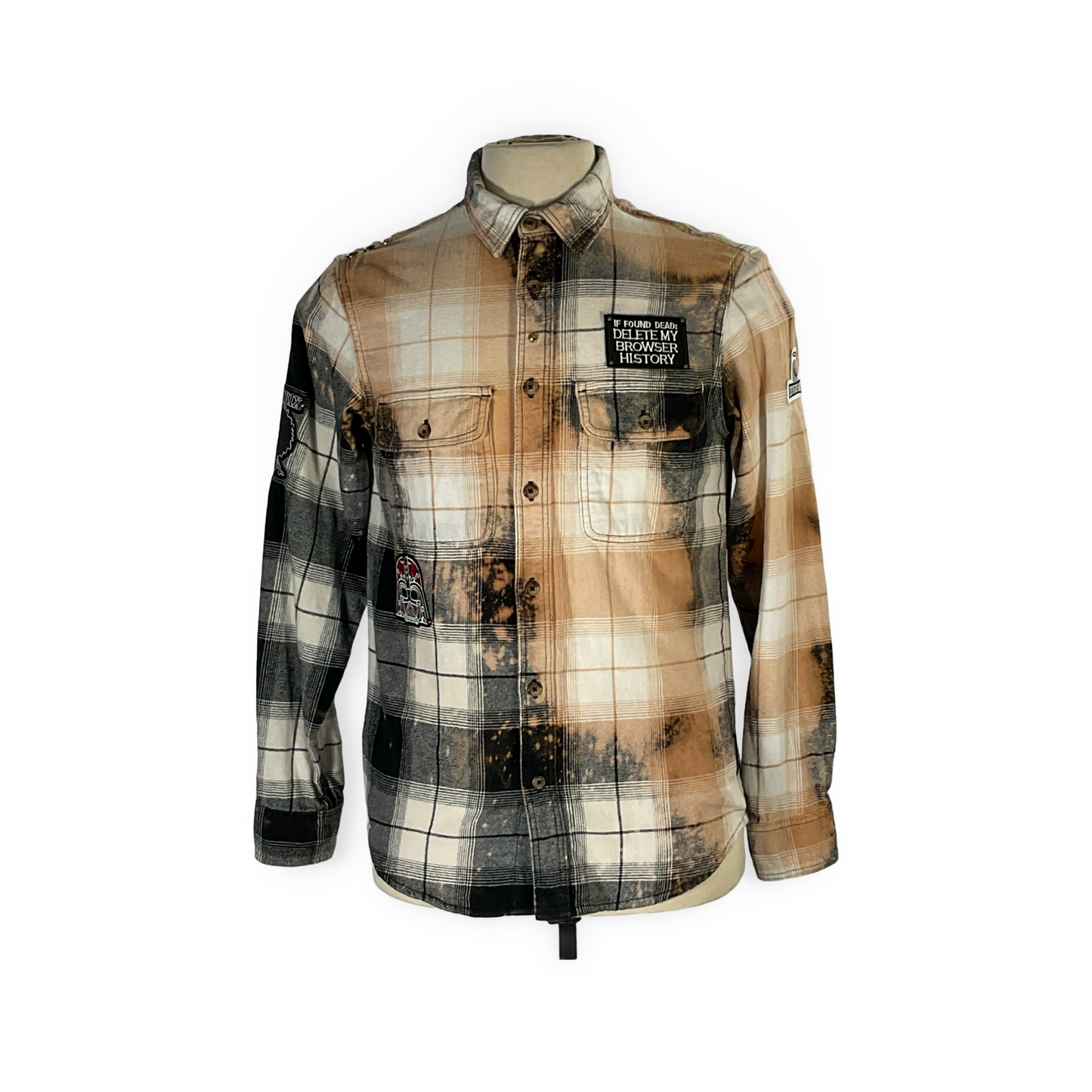 Close-up of the unique Cyber Bear flannel, showcasing hand-patched details, metal studs, and a bleached finish, epitomizing sustainable, bold fashion from reclaimed cotton.