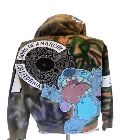 STICH Custom Men's Hoodie with unique character stitching, edgy design, and graffiti-inspired artwork, worn by a person, reflecting bold, wearable art by DEVIOUS SAINT.
