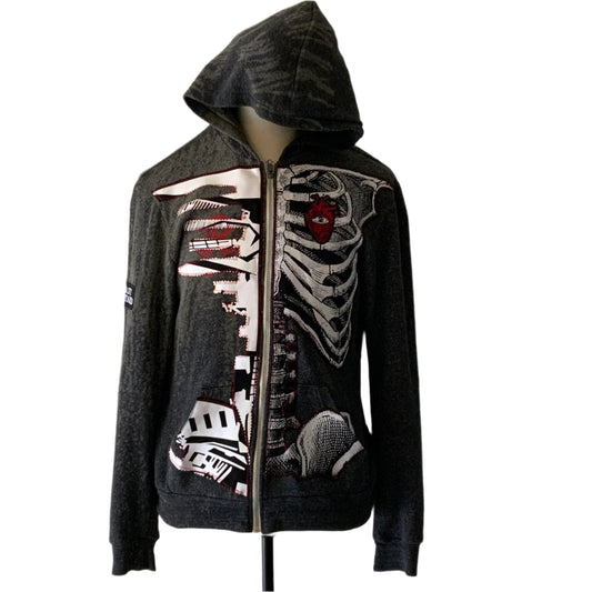 Charcoal-gray zip-front hoodie with cityscape and ribcage art, featuring a red heart. Medium size, embodies Bauhaus-inspired design and understated sophistication.