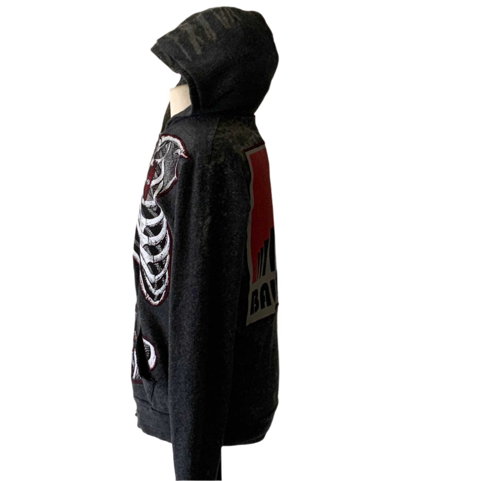 Charcoal-gray hoodie with a white skeleton motif on front, red-and-black patch on back, embodying Bauhaus style, size medium.