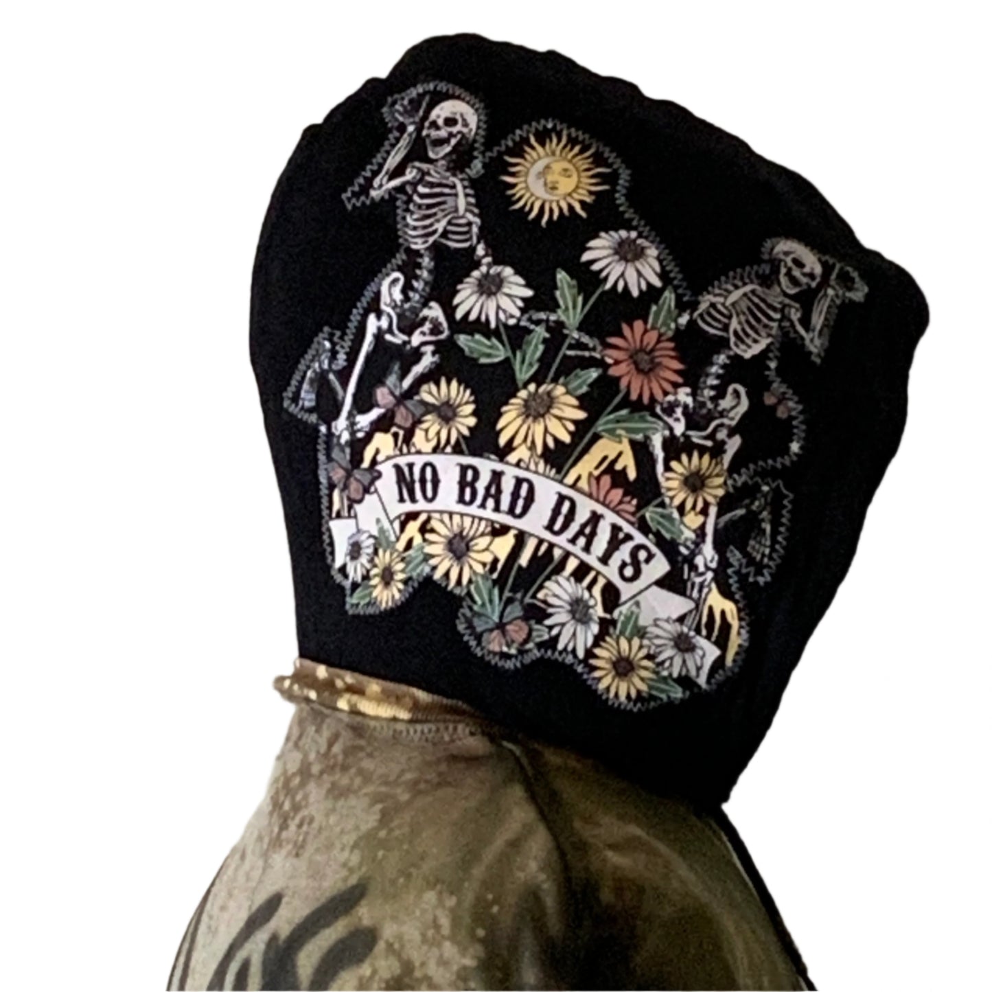 Back view of the I'M NOT THE DREAM hoodie showcasing dancing skeletons and daisies with No Bad Days banner, worn over an olive-green jacket.