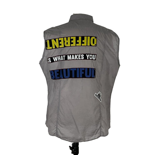 DIFFERENT IS BEAUTIFUL men's sleeveless shirt, featuring bold text design on a grey fabric, embodying unique, distinctive style from DEVIOUS SAINT.