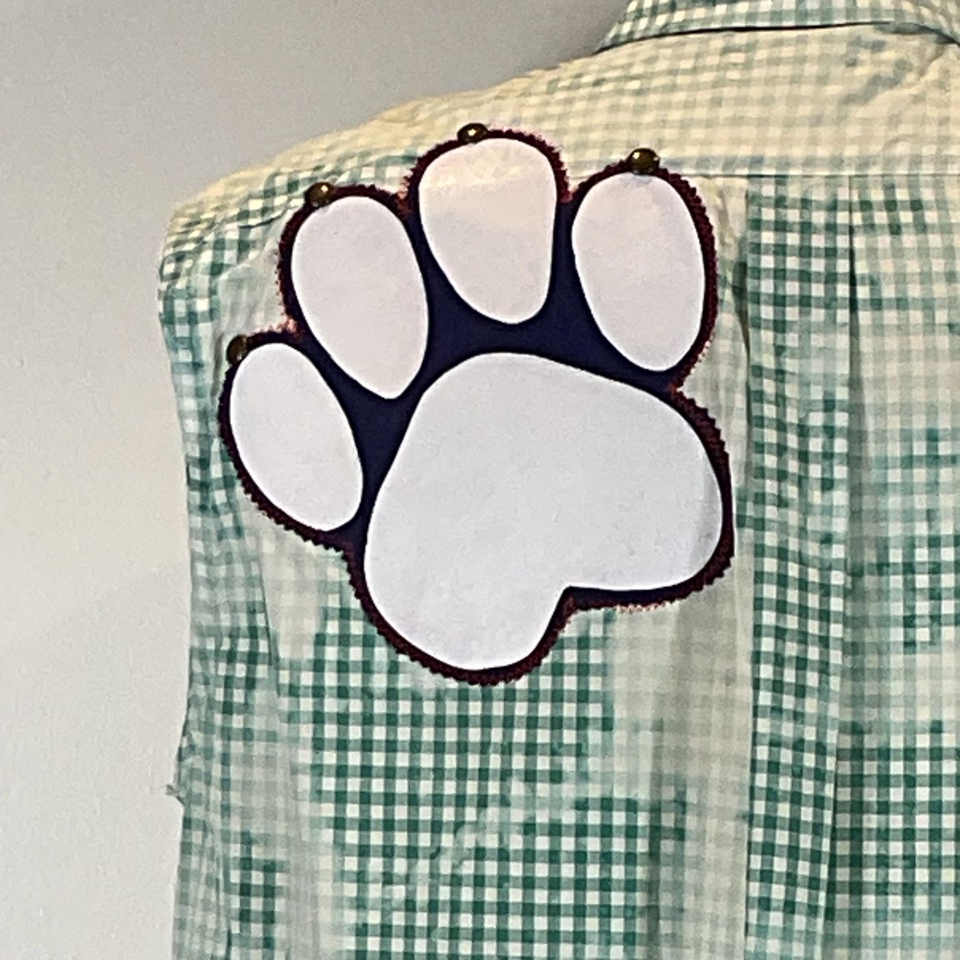 PAW Men's Custom Sleeveless Shirt featuring a white paw patch on a green and white plaid pattern, reflecting DEVIOUS SAINT's unique, bold fashion style.