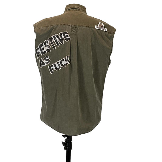 FESTIVE AS FUCK Men's Custom Sleeveless Shirt featuring military green fabric with unique patches, reflecting bold, distinctive wearable art from DEVIOUS SAINT.