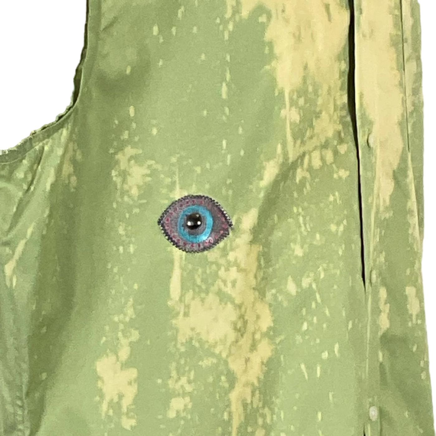 Men's custom sleeveless shirt featuring a green vest with a distinctive blue eye patch, embodying DEVIOUS SAINT's bold, unique style.