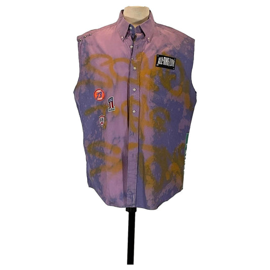 DEVIOUS SAINT Men's Custom Sleeveless Shirt, extra-large, features unique patches on a purple vest, showcasing bold wearable art.