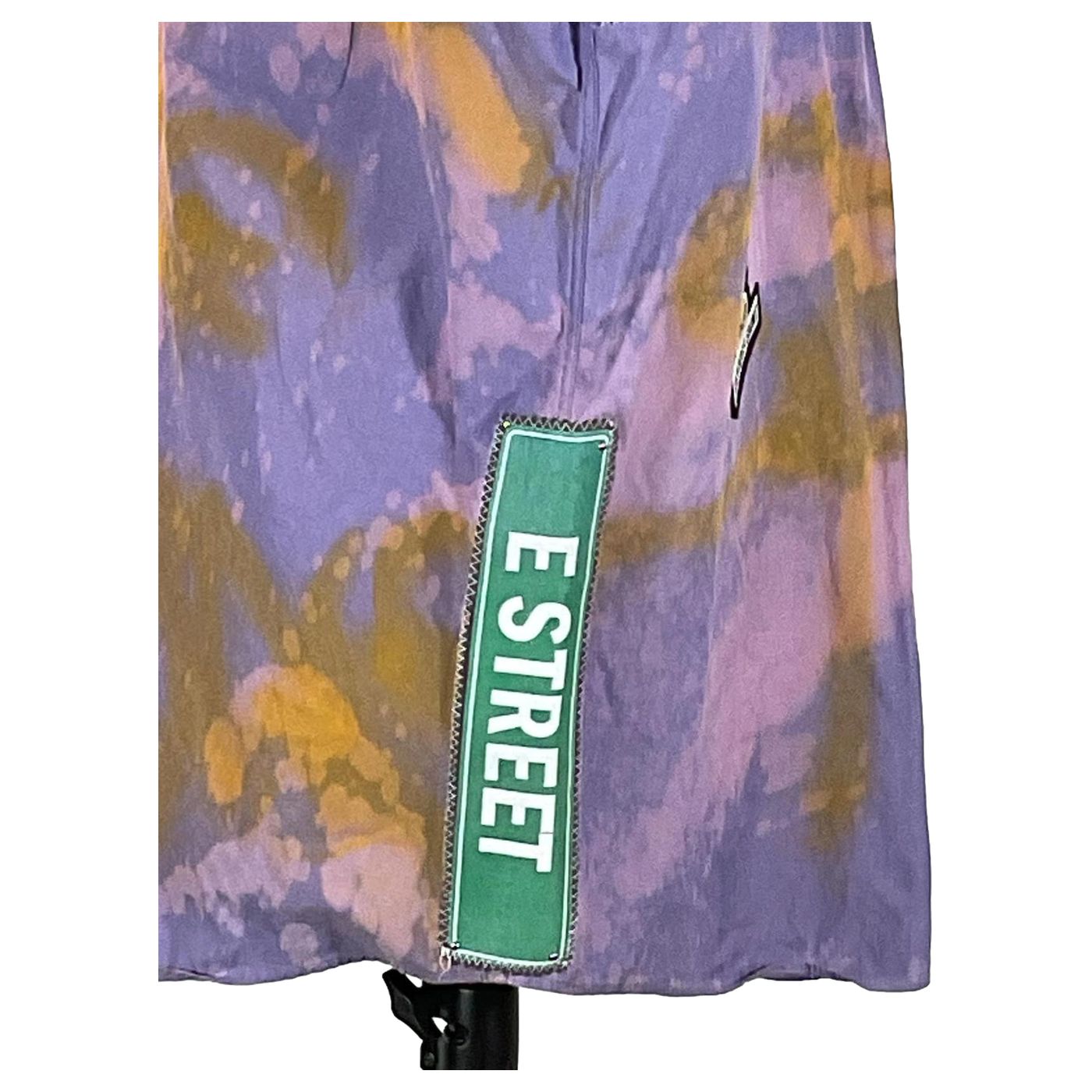 DEVIOUS SAINT Men's Custom Sleeveless Shirt, showcasing a purple and yellow tie-dye design, embodies unique wearable art with bold patterns and distinctive style.