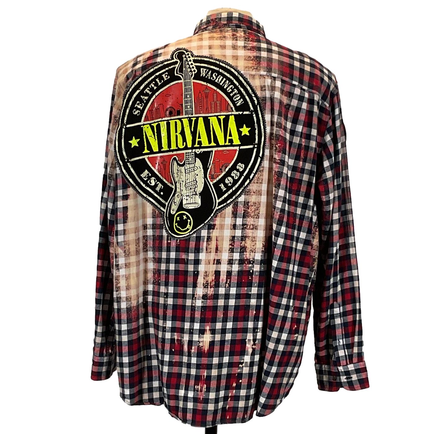 NIRVANA Men's Custom Long-Sleeve Flannel Shirt with plaid pattern and logo, emphasizing unique, bold design from DEVIOUS SAINT, size XX-Large.
