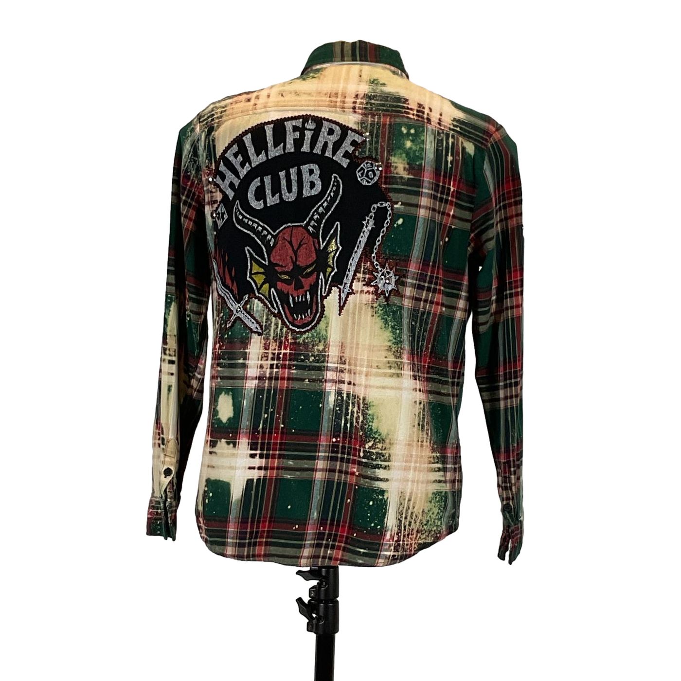 HELLFIRE Men's Custom Long-Sleeve Flannel Shirt displayed on a mannequin, featuring a plaid pattern with a distinctive skull patch.