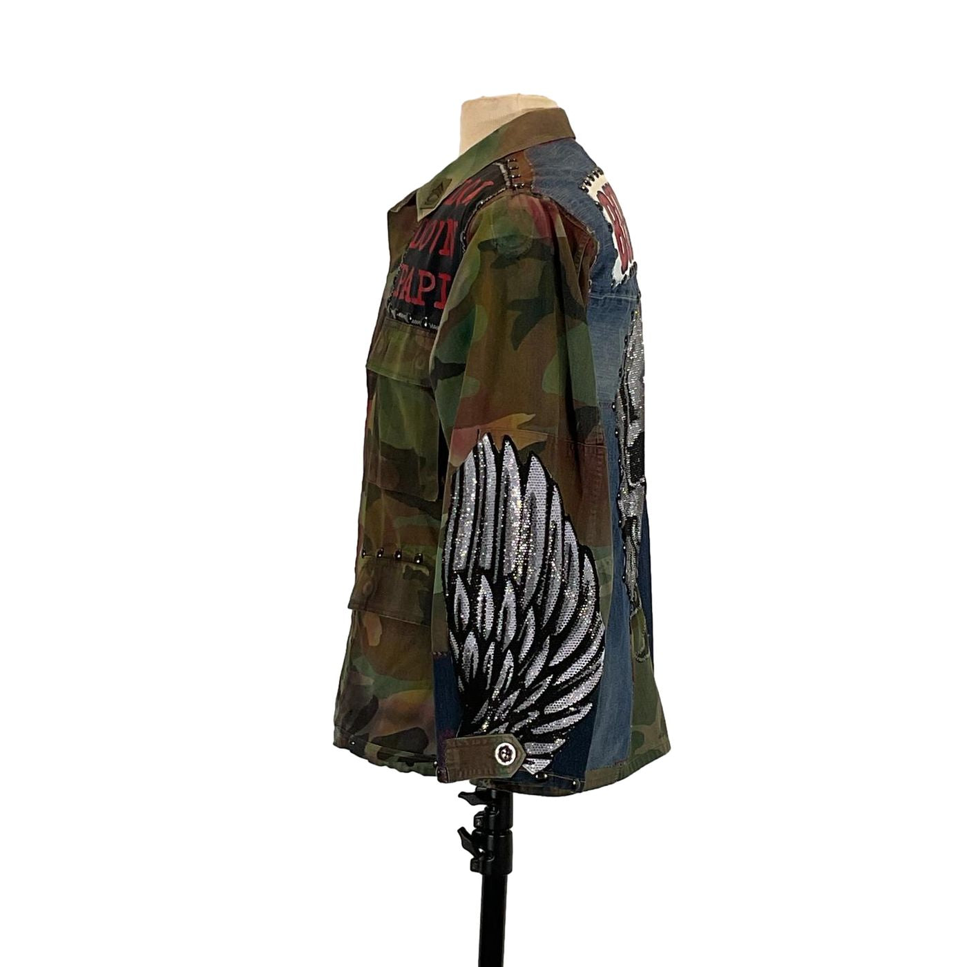 BUITRES Men's Custom Jacket by Devious Saint on a mannequin, featuring camouflage pattern and rhinestones, highlighting its unique, bold design.