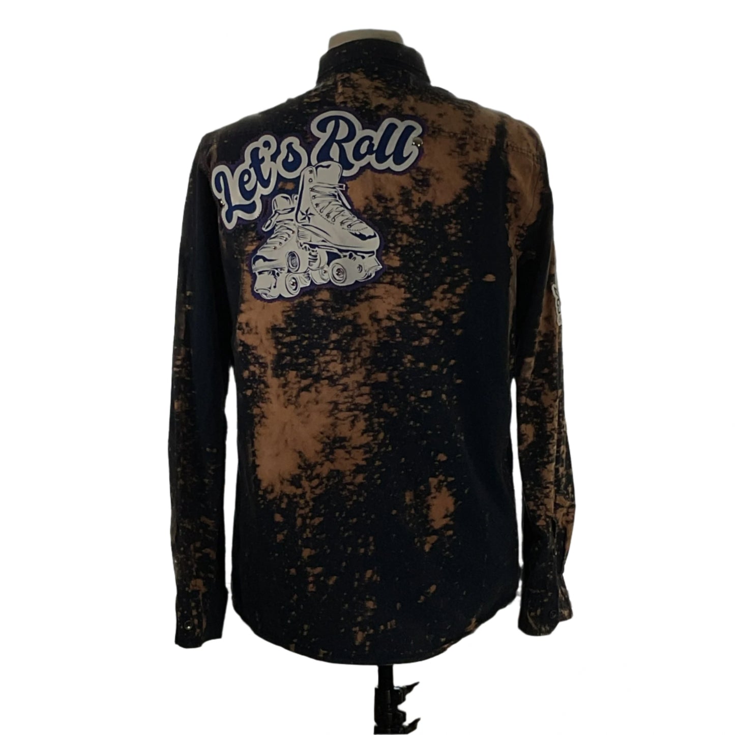 Men's custom long-sleeve flannel shirt, LET’S ROLL!, with roller skate graphic on the back, embodying Devious Saint's unique, bold style.