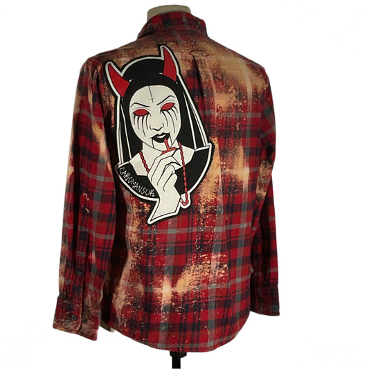 Caromamsour Men's custom long-sleeve flannel shirt in red plaid features a bold cartoon face with red eyes, capturing DEVIOUS SAINT's unique and daring style.