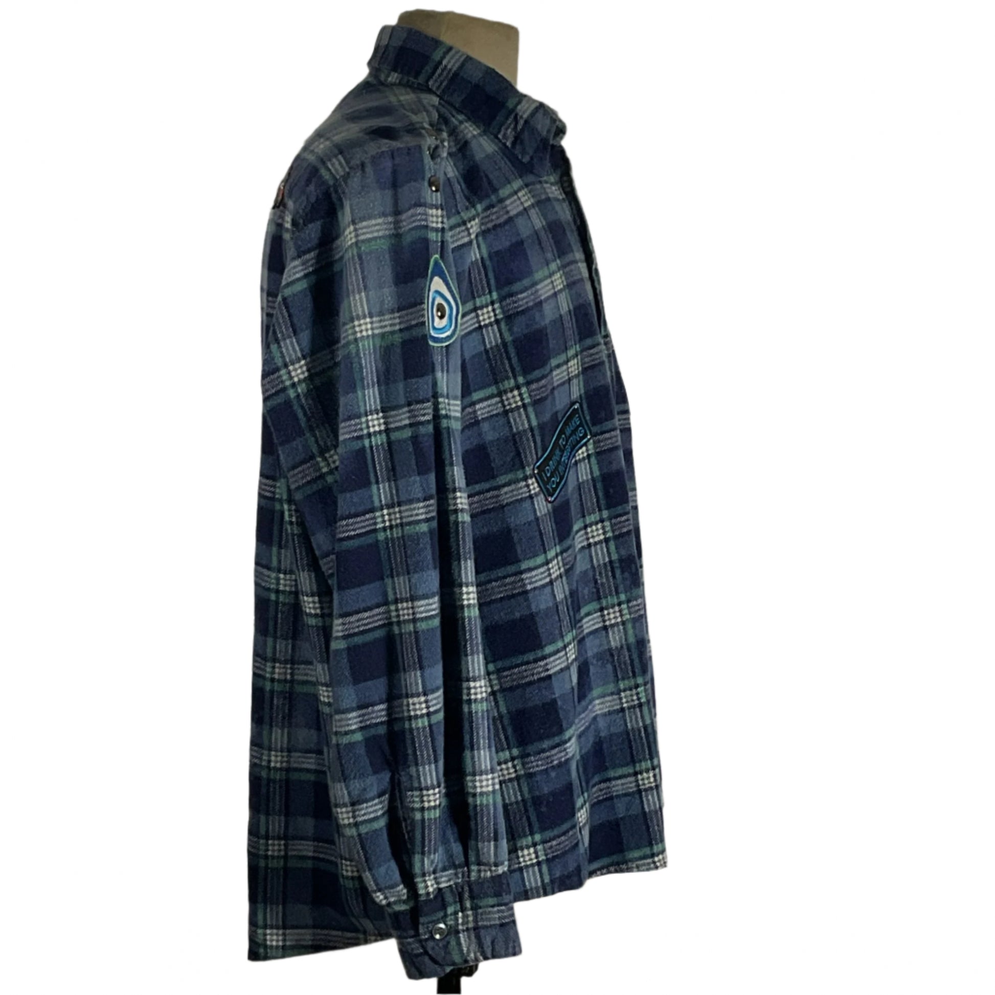 Iron Maiden Men's Custom Long-Sleeve Flannel Shirt on mannequin, showcasing bold plaid design and rugged flannel texture, reflecting Devious Saint's unique, wearable art style.