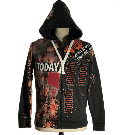Close-up of the AFFLICTION Custom Men's Hoodie, showcasing intricate graffiti patchwork and sleeve detail, exemplifying DEVIOUS SAINT's distinctive and bold wearable art style.