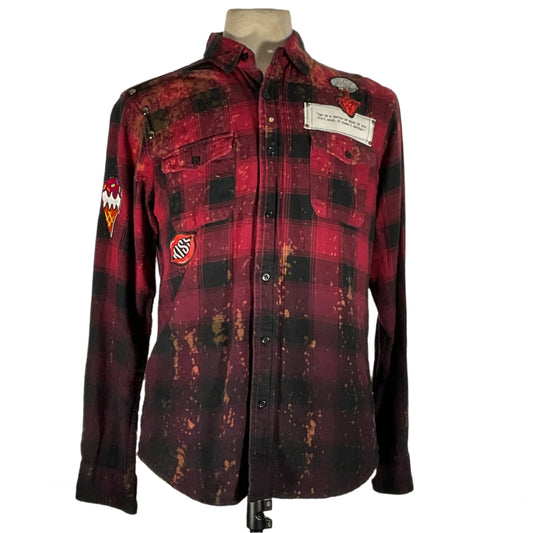 BATMAN/SPIDERMAN custom long sleeve flannel, featuring hand-patched details and metal studs, displayed on a mannequin. Sustainable, unique design by DEVIOUS SAINT, size small.