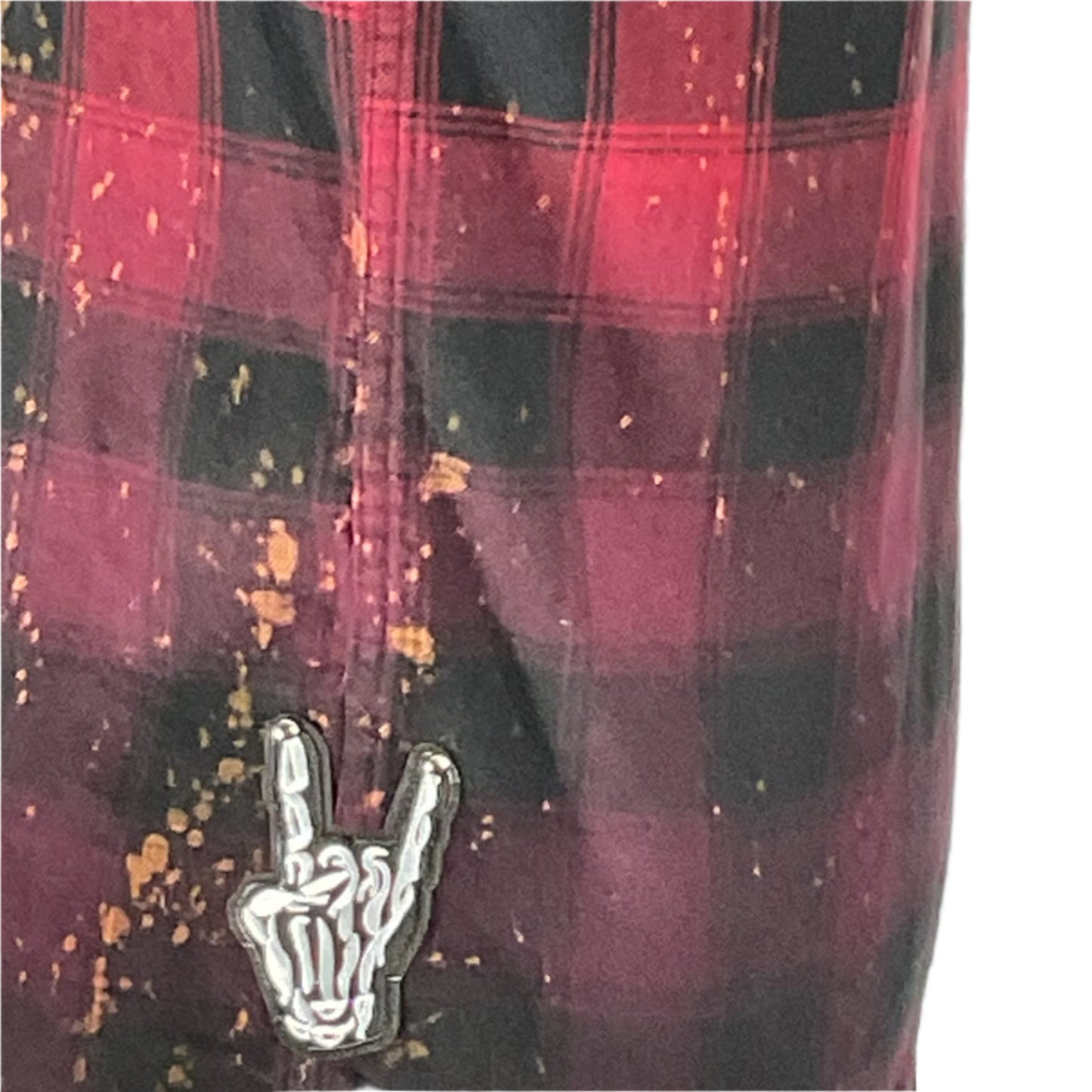 Close-up of a custom long sleeve flannel, BATMAN/SPIDERMAN, showcasing hand-patched details and metal studding, embodying a unique vintage aesthetic with a heroic theme.