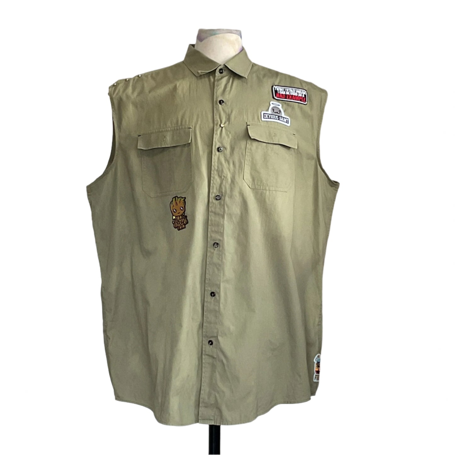 PINK GUMMY BEAR | Men's Custom BEAR SIZE Sleeveless Shirt | 3 XL, featuring assorted patches, including BAD EXAMPLE and a tree-creature, on an olive-green/khaki fabric.