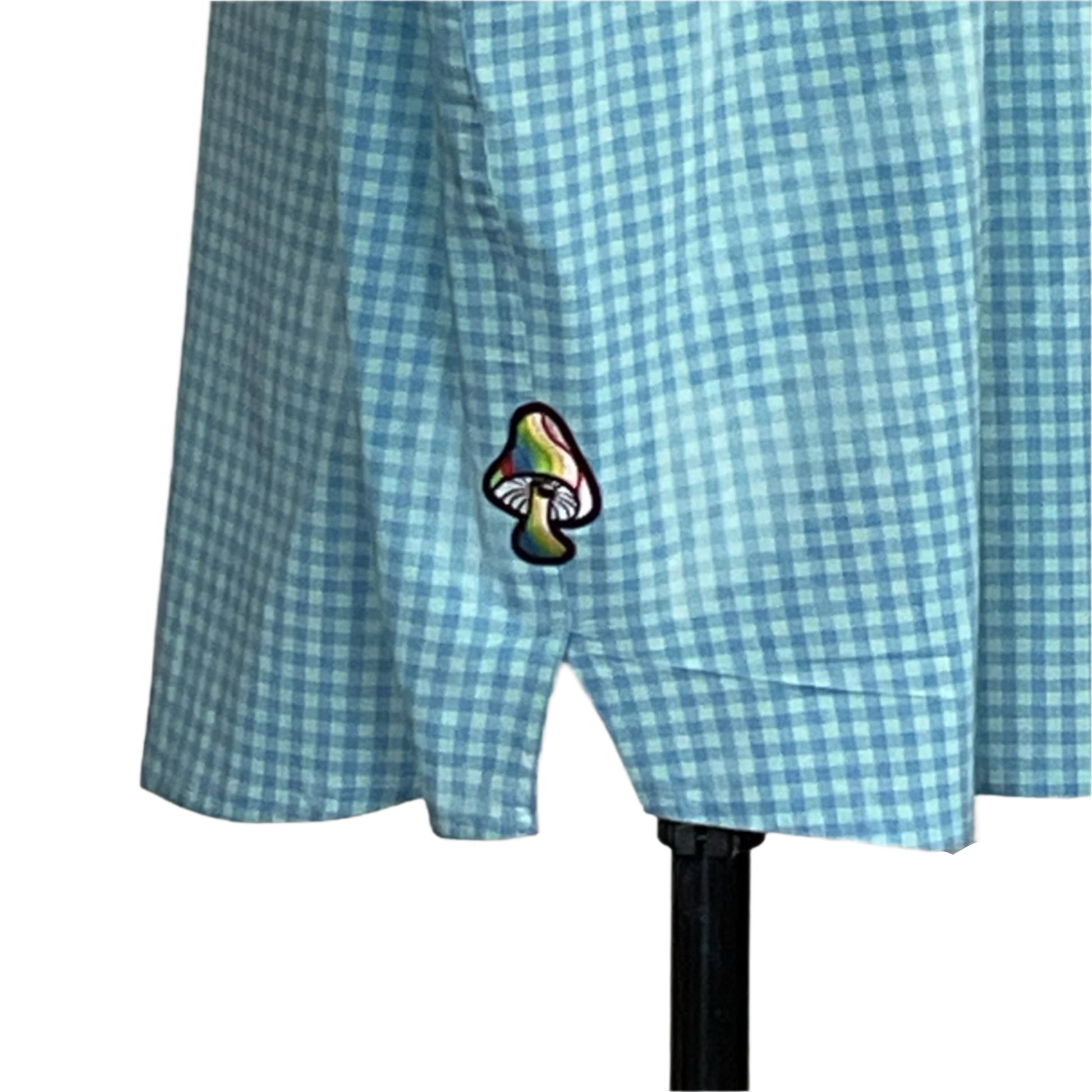 Light-blue gingham skirt with a rainbow mushroom patch near the hem on a dress form, part of the WARNING: YOU COULD GO BLIND… collection by DEVIOUS SAINT.