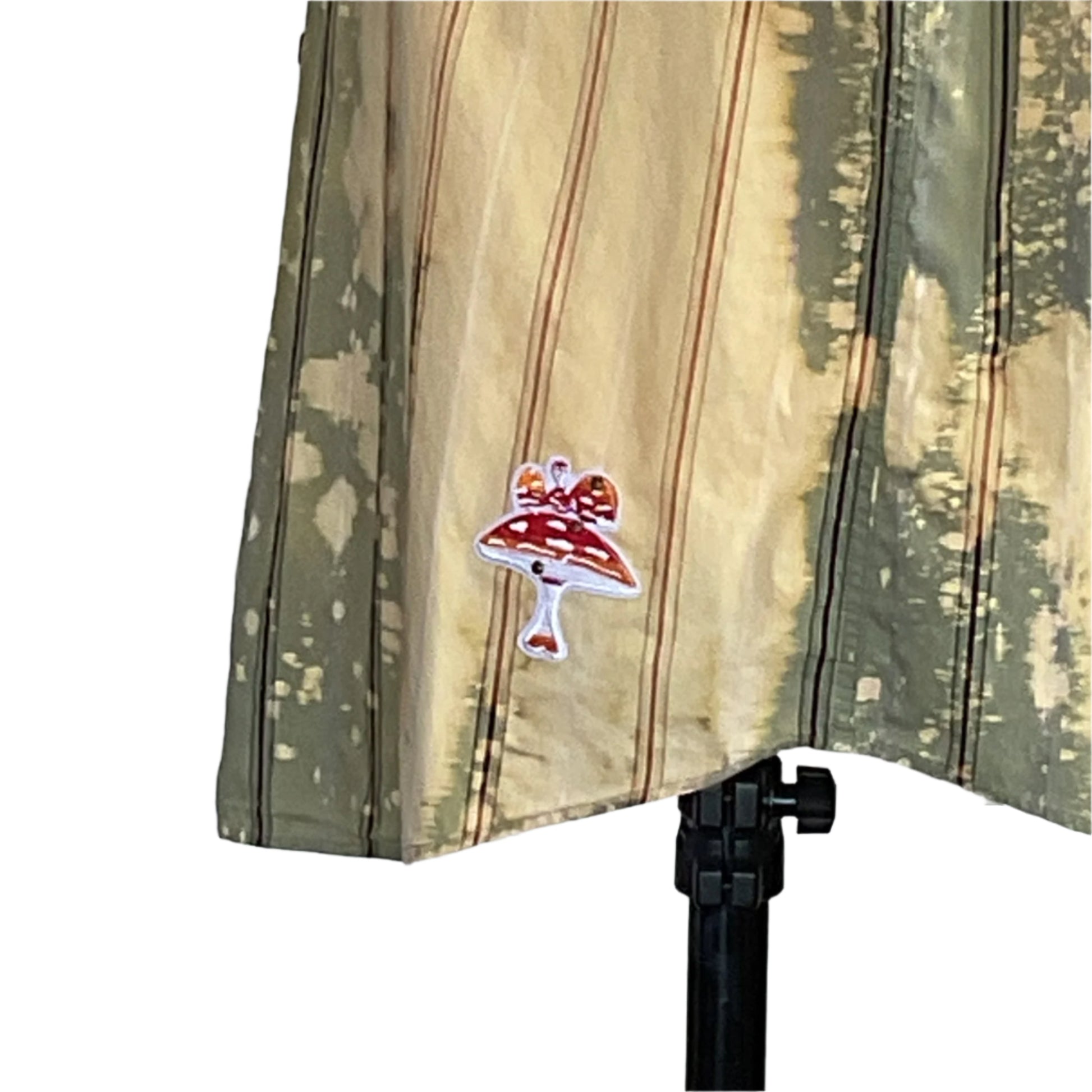 PAPA BEAR extra-large sleeveless shirt with green-and-tan stripes, featuring an embroidered red-and-white toadstool patch, draped on a black tripod stand.