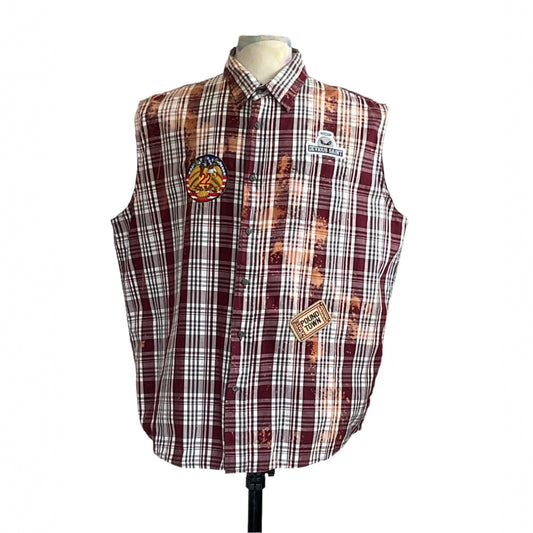MASKED MONA LISA sleeveless plaid shirt with bleach splatters, eagle patch, and DEVIOUS SAINT branding, displayed on a mannequin.
