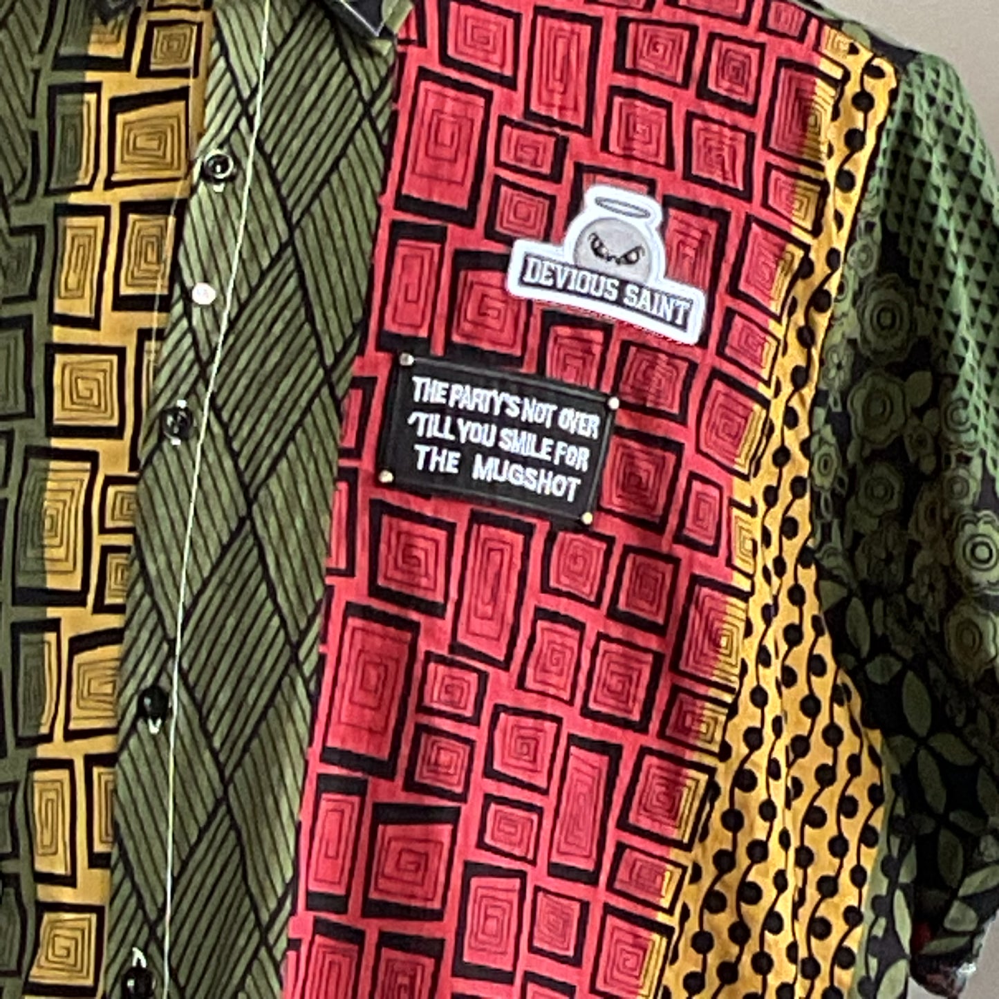 DRINK UP Men's Custom BEAR SIZE Sleeveless Shirt in 3XL features a vibrant patchwork of geometric prints with unique patches, embodying bold, distinctive style.
