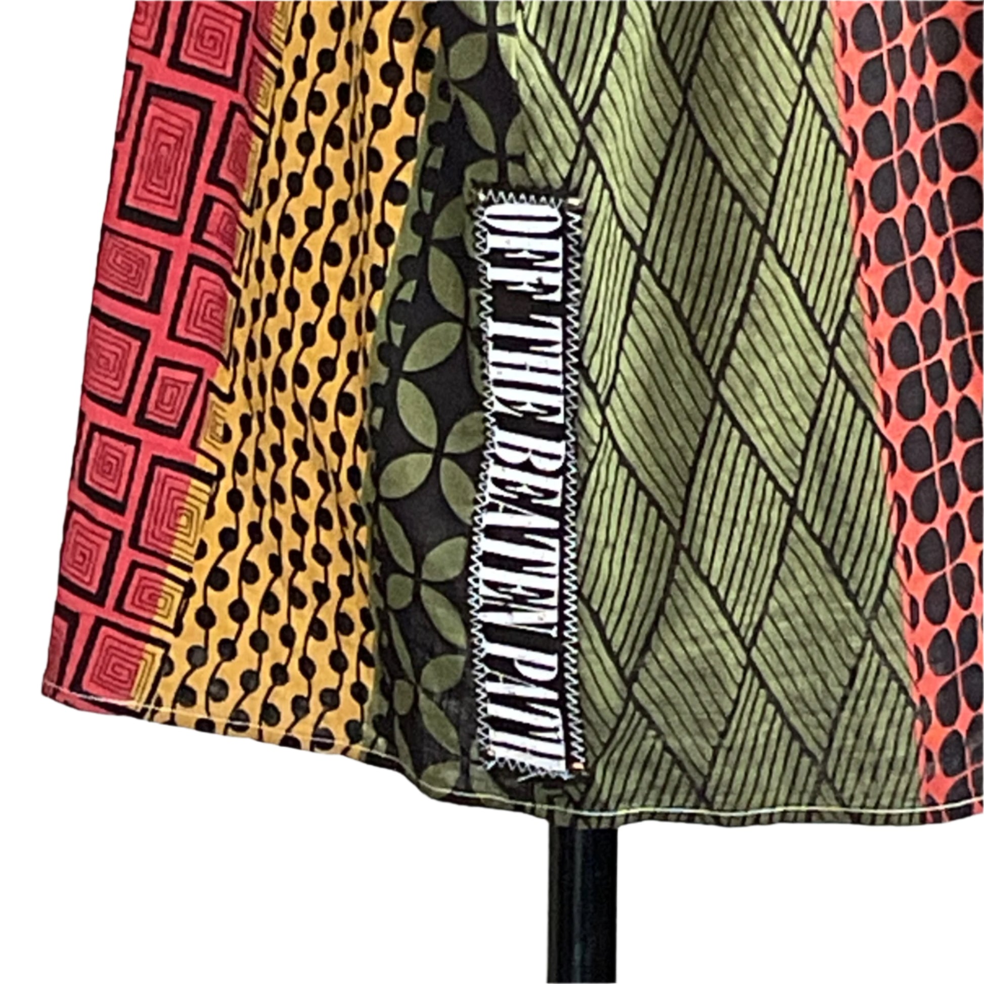 DRINK UP Men's Custom BEAR SIZE Sleeveless Shirt in 3XL features a vibrant patchwork hem with geometric prints and a stylized text patch.