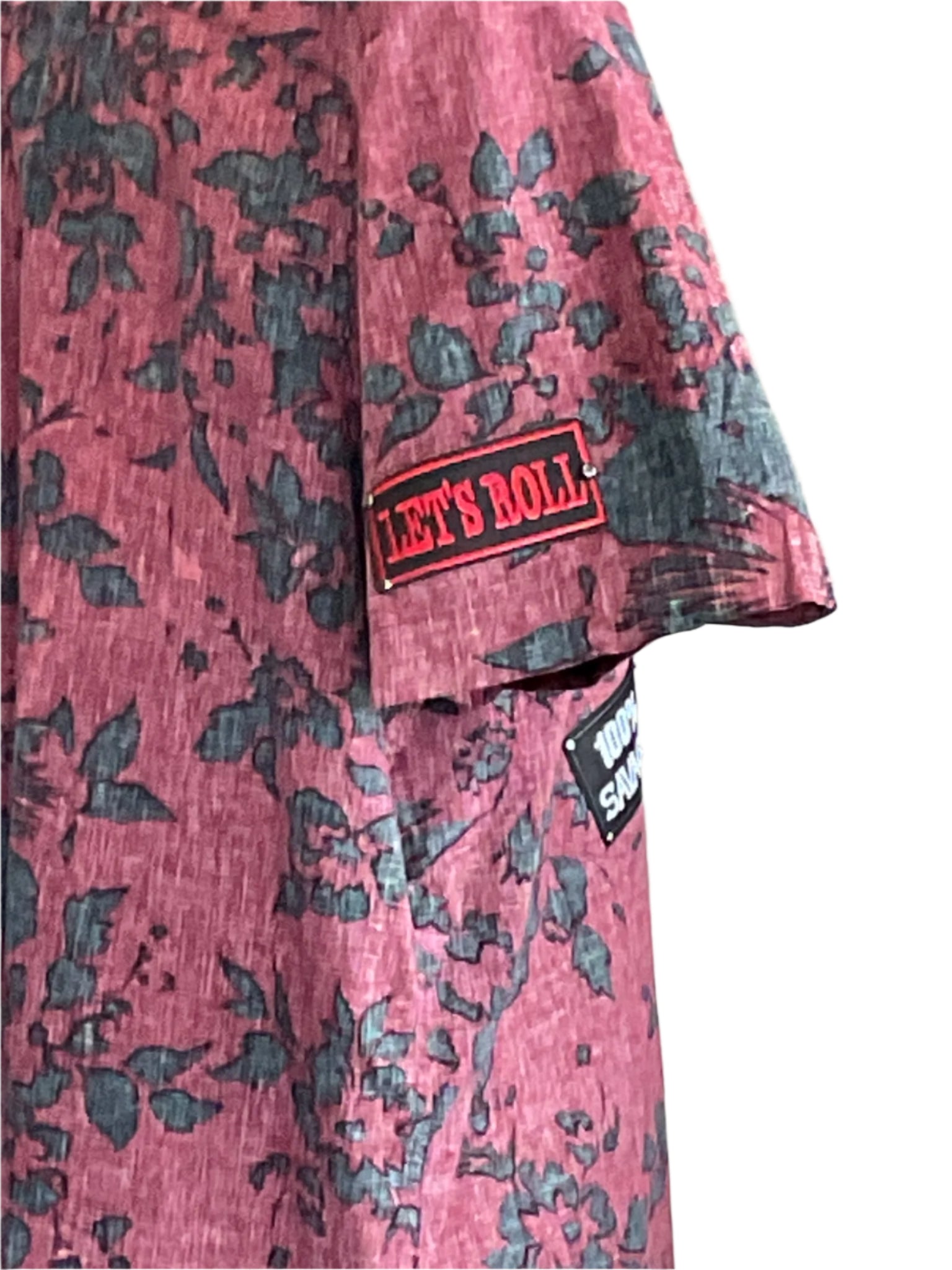 Men's 2XL short sleeve shirt with red floral pattern, featuring LET'S ROLL patch; playful, bold design reflecting DEVIOUS SAINT's unique wearable art style.