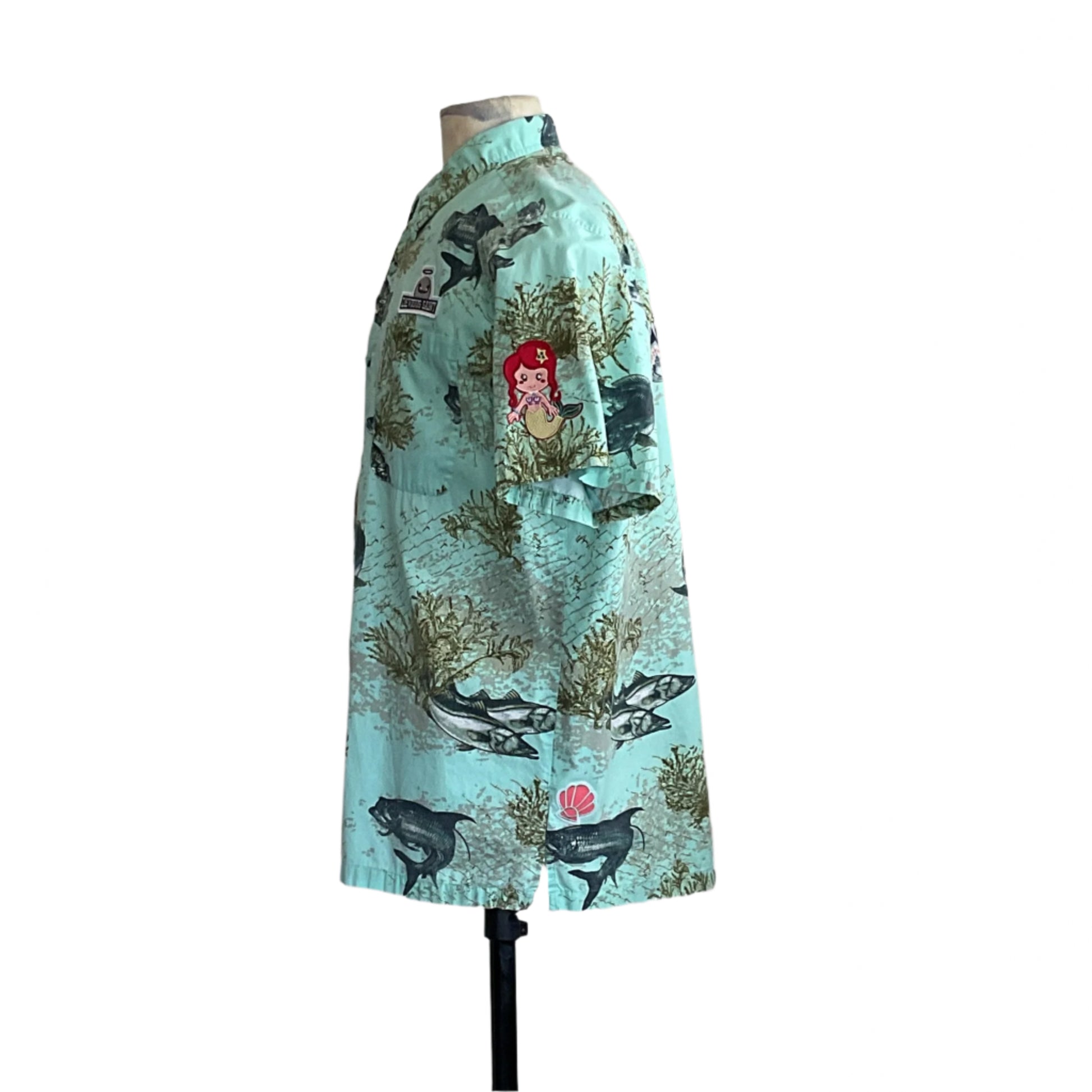 AQUA BONE FISH | Men's Custom BEAR SIZE Short Sleeve Shirt in pale sea-foam green, featuring large fish, seaweed design, and mermaid patch. Size: Extra Large.