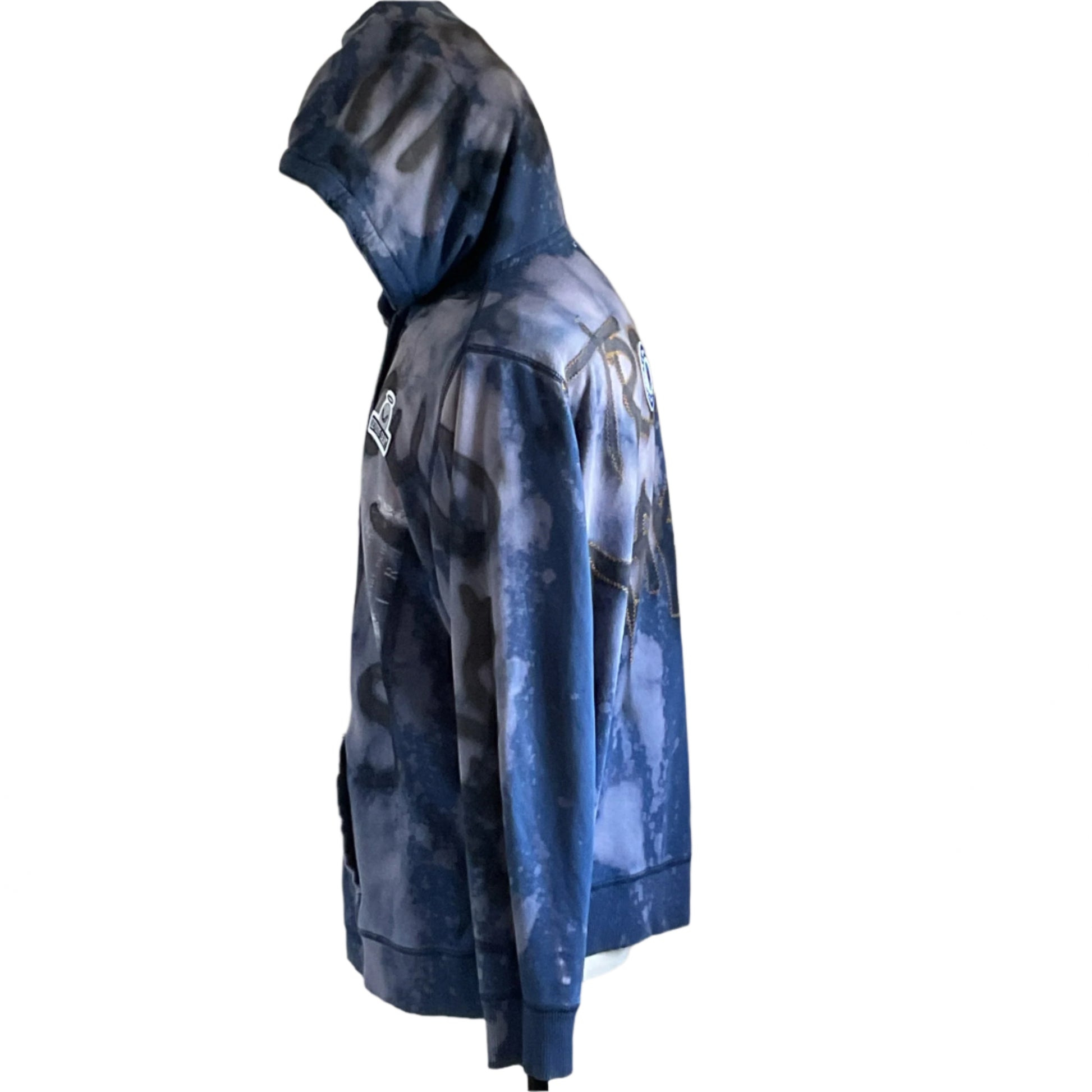 Side profile of TROUBLE MAKER eCustom Men's Hoodie by Devious Saint, featuring a tie-dye navy camouflage pattern, chest logo, and back lettering detailing.