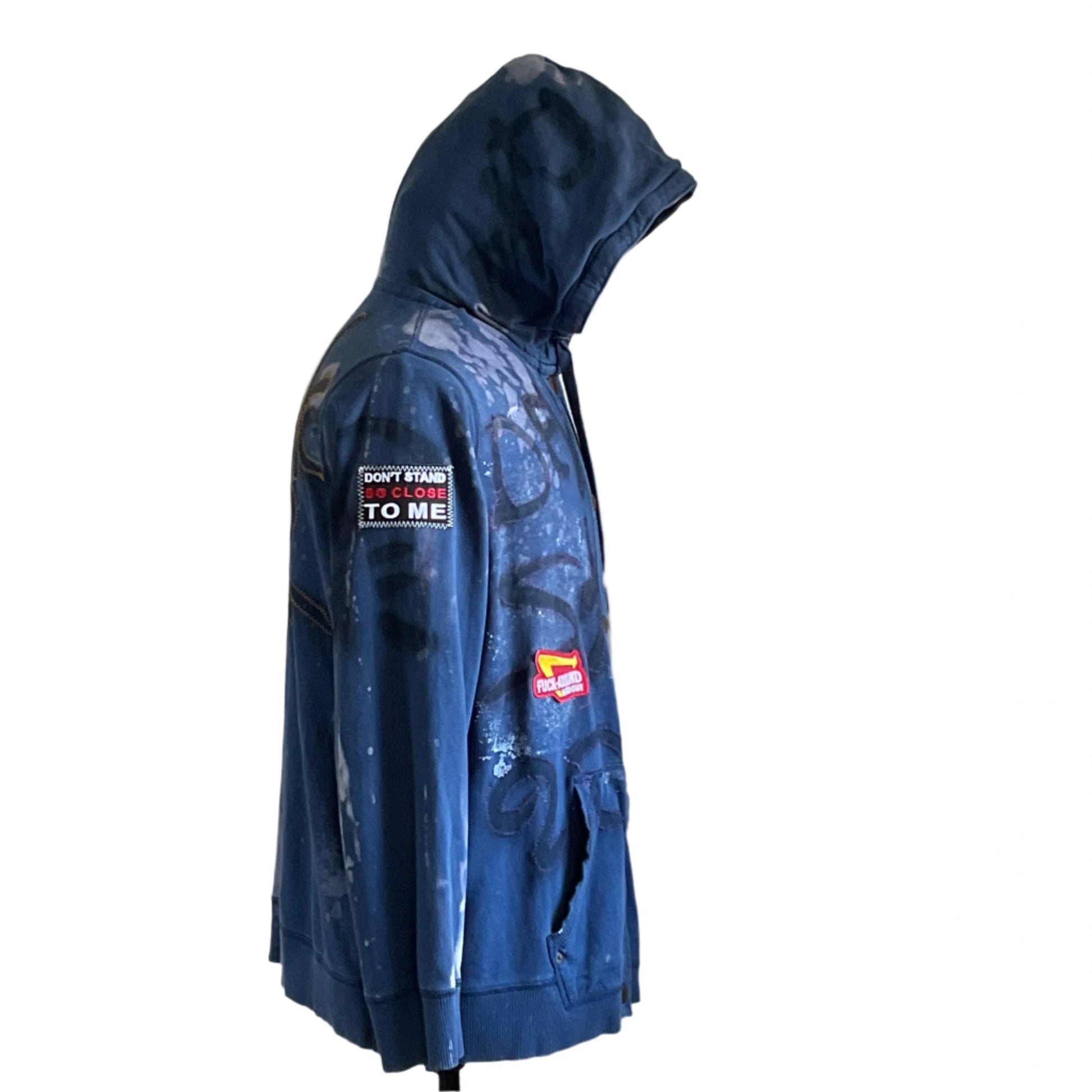 TROUBLE MAKER | eCustom Men's Hoodie by Devious Saint: Navy zip-front hoodie with bleach splatters, graffiti markings, and patches, showcasing rebellious, unique style.