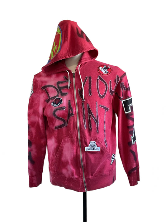 DEVIOUS SAINT Custom Men's Hoodie with tie-dye effect, graffiti lettering, and unique patches, showcasing bold and distinctive style on a mannequin.