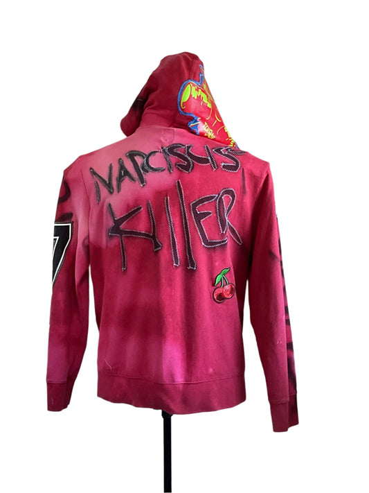 “DEVIOUS SAINT” Custom Men's Hoodie with stitched “NARCISSYS KILLER” graffiti-style text and cherry patch on back, featuring a colorful graphic-lined hood.